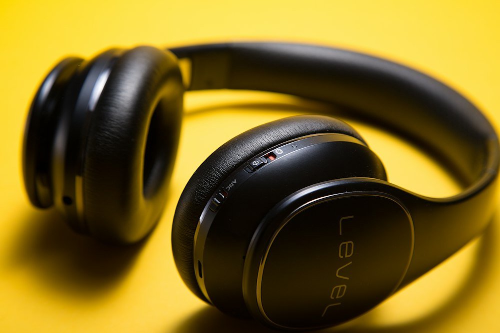 Is It Bad To Wear Noise Cancelling Headphones While Sleeping? black Level wireless headphones on yellow surface