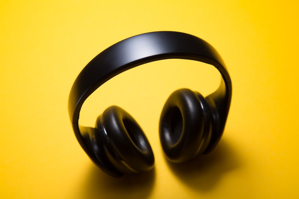 Is It Bad To Wear Noise Cancelling Headphones While Sleeping? wireless headphones with yellow background